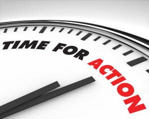 White clock with words Time for Action on its face